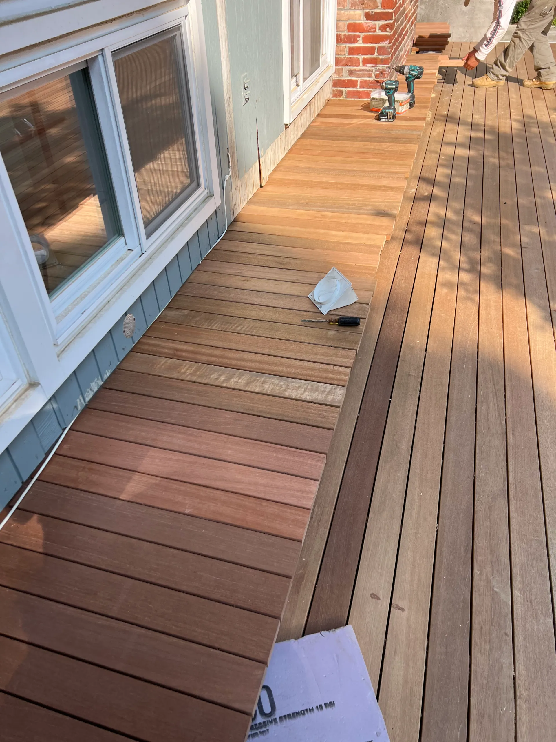 Hardwood deck running along the side of a Hamptons home