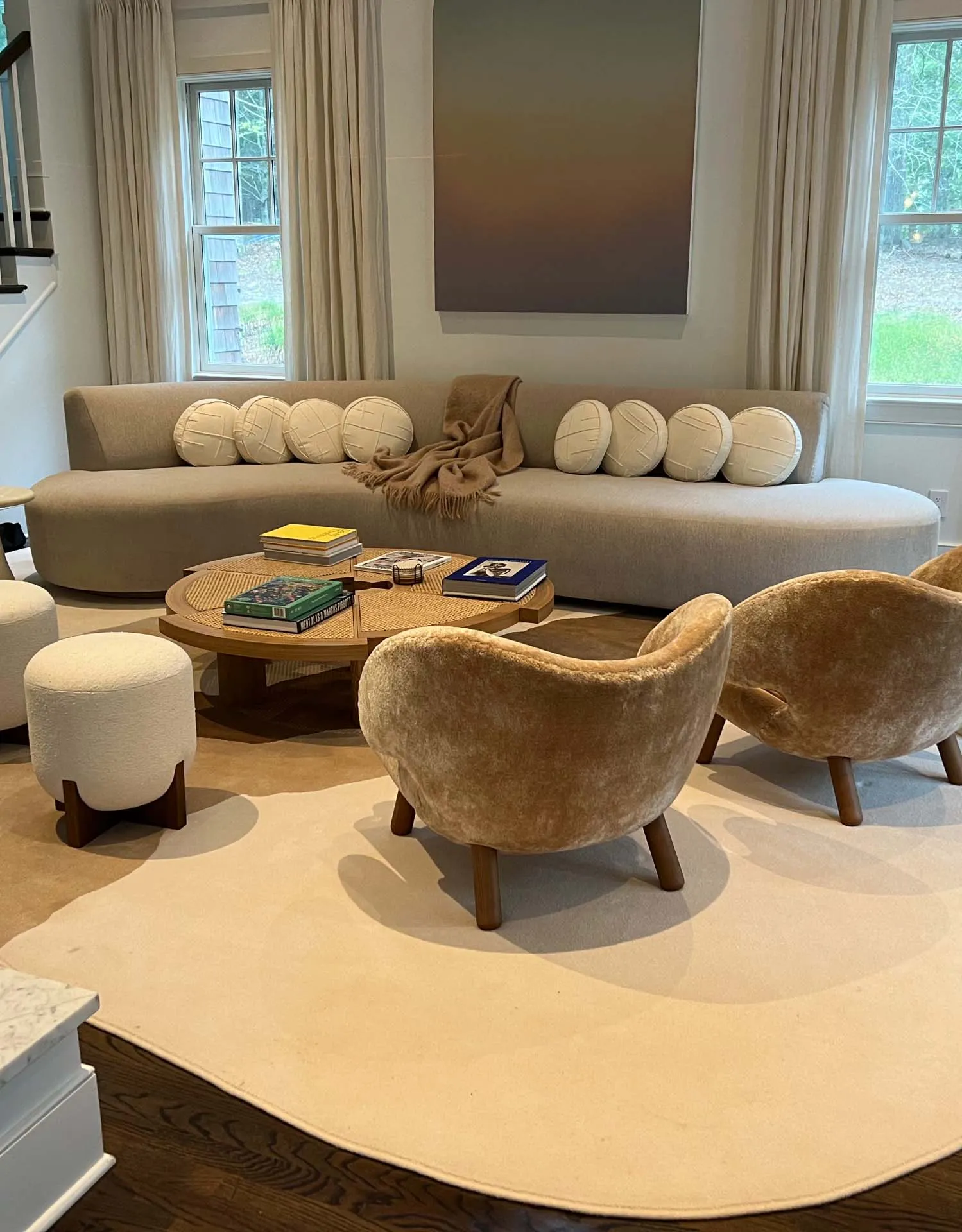 Renovated living room with a curved sofa and sculptural chairs