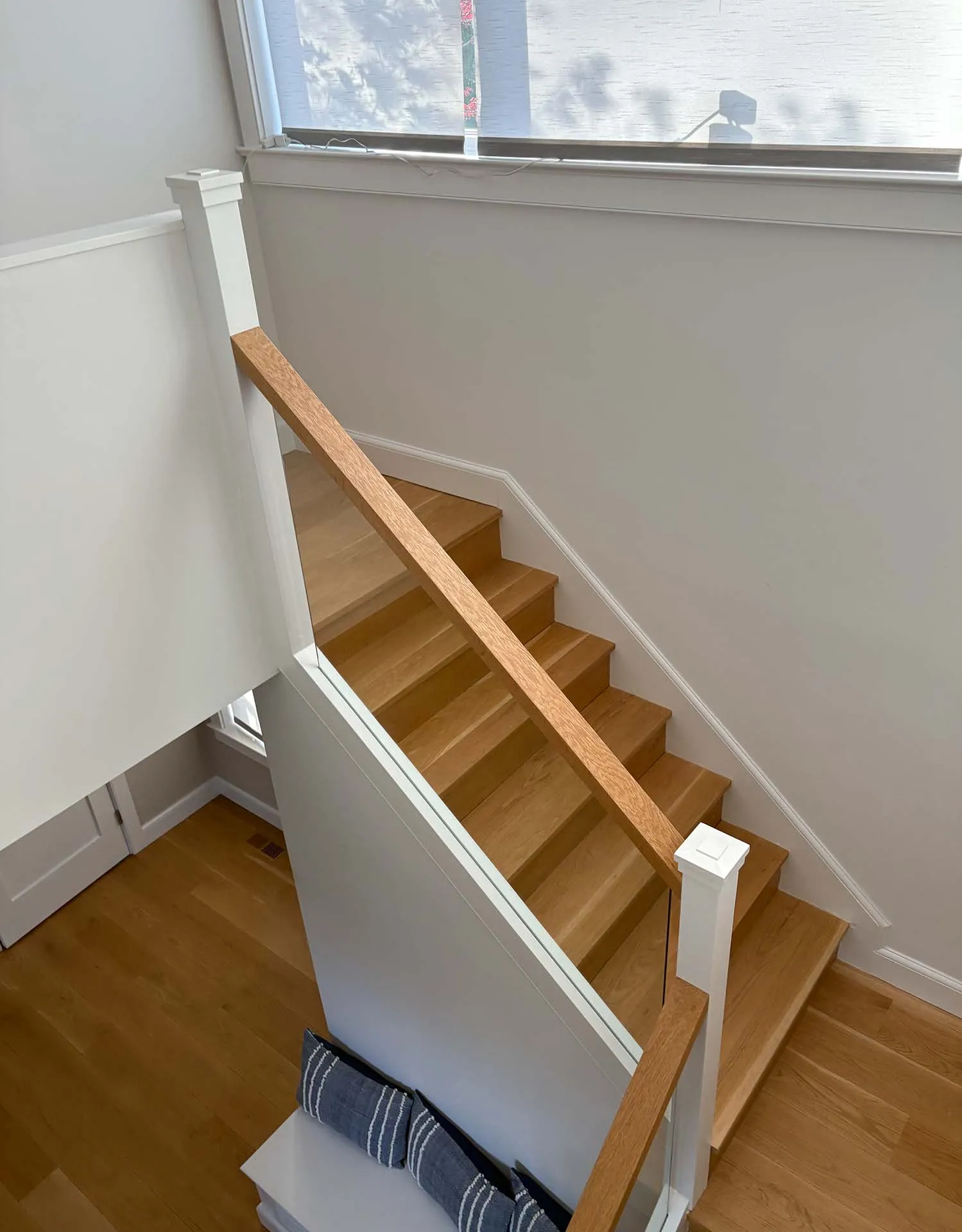 White oak staircase with a white painted railing